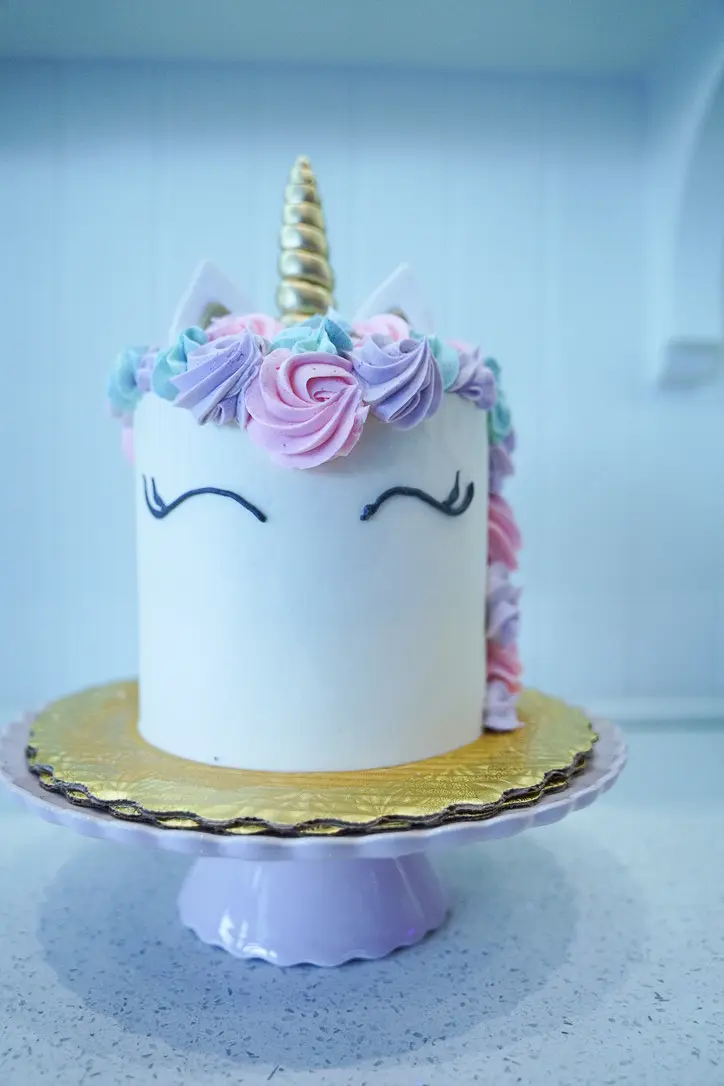 Pastel Unicorn cake with buttercream flowers and a gold horn