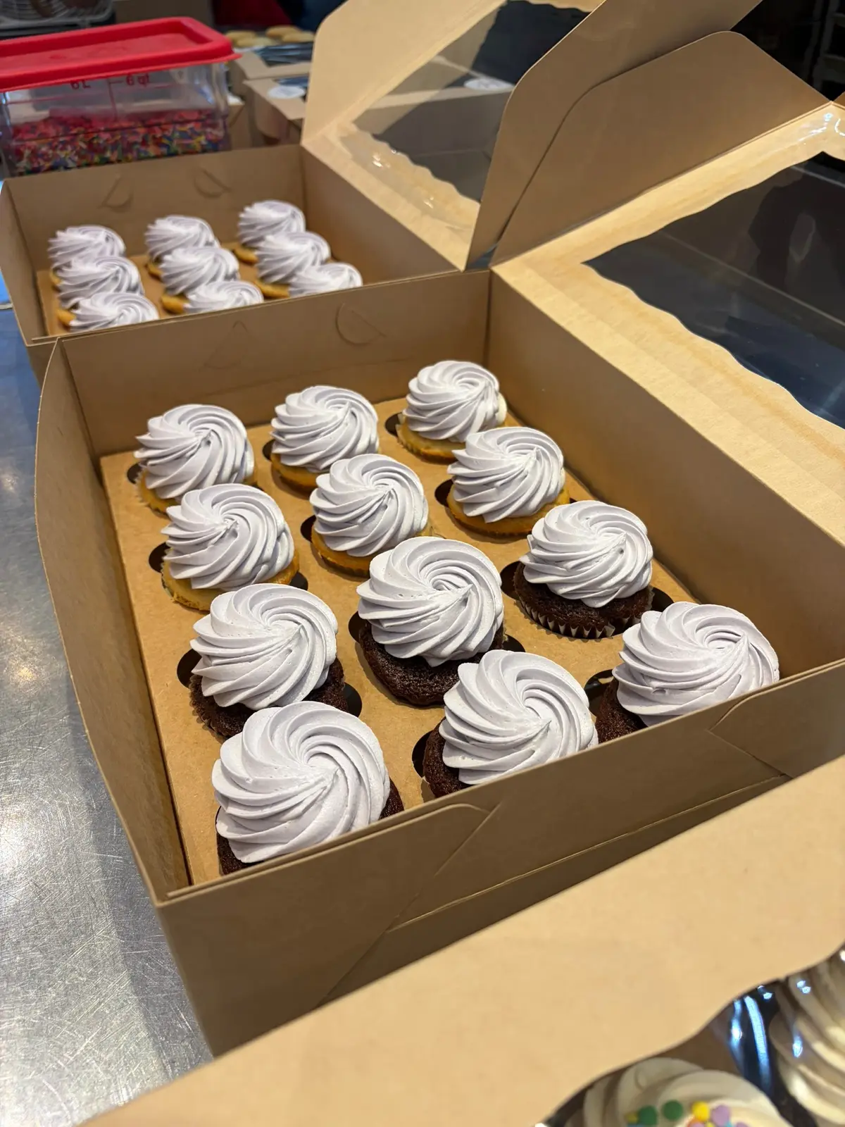 Fresh cupcakes packed in bakery boxes