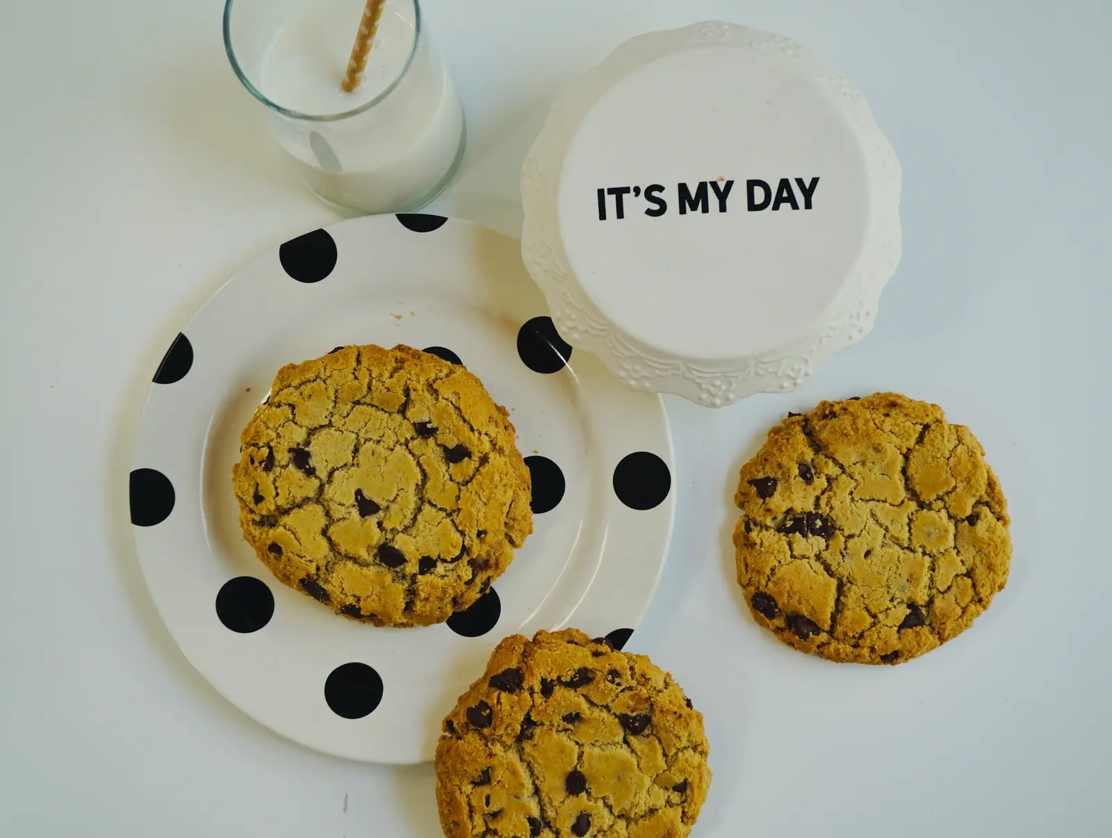 Three oversized celebration cookies on a plate